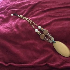 I am selling a gold necklace with wood design.